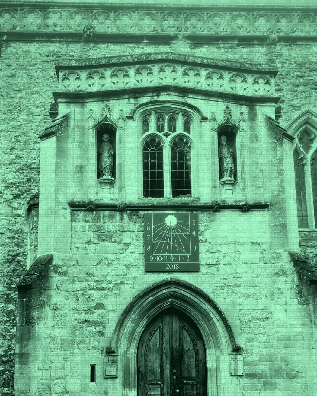 A stone facade centered on a sundial and arched doorway, rendered with numeric glyphs.